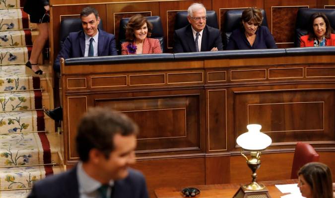 El líder del PP, Pablo Casado (delante), pasa junto al candidato socialista, Pedro Sánchez (izda detrás), entre otros, mientras se dirige a la tribuna durante la segunda y definitiva votación de investidura. EFE/Ballesteros