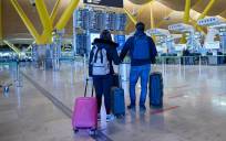Dos personas con maletas en el aeropuerto Adolfo Suárez, Madrid-Barajas. / E.P.