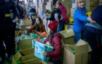 Varias voluntarios organizan las cajas de ayuda humanitaria, en un pabellón, cerca de la frontera con Polonia. / Lorena Sopêna - Europa Press