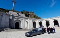 El prior de la Basílica Santiago Cantera (c) junto a los familiares de Francisco Franco tras introducir el féretro en el coche fúnebre. / El Correo