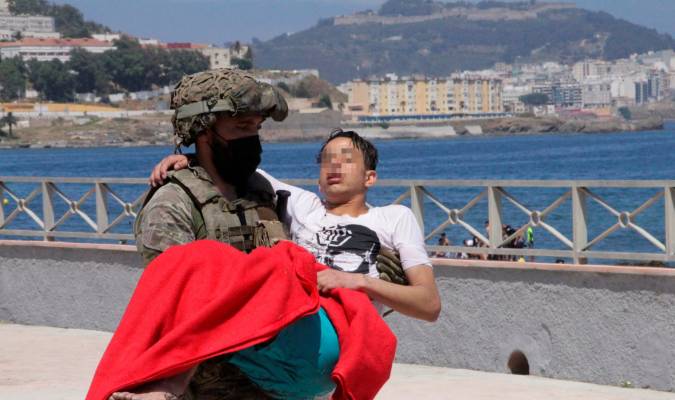 Un soldado traslada a un inmigrante en la playa fronteriza de El Tarajal de Ceuta,. EFE/ Reduan