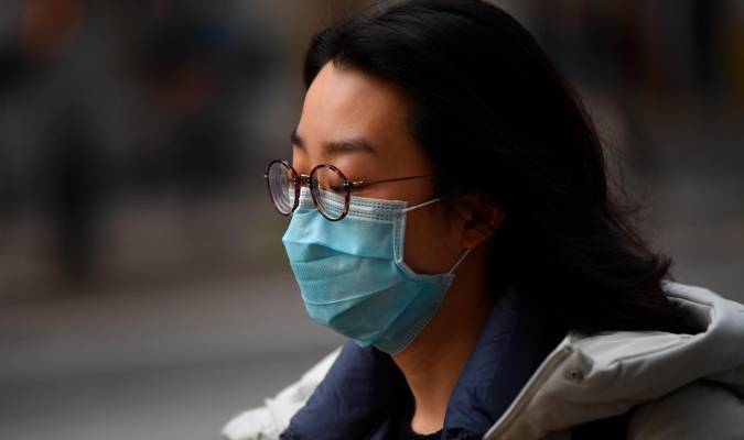 Una mujer con mascarilla para evitar un posible contagio. / EFE