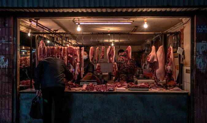 En la imagen de archivo, una mujer vende carne en un mercado de un área residencial de Wuhan, China. EFE/EPA/ROMAN PILIPEY