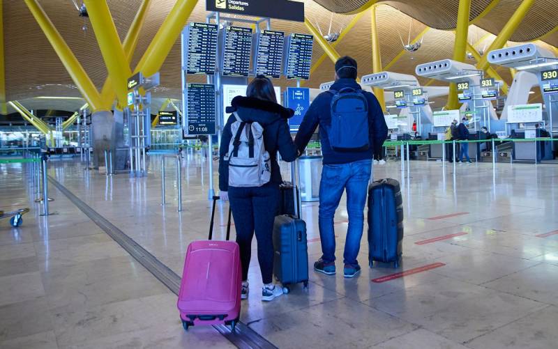 Dos personas con maletas en el aeropuerto Adolfo Suárez, Madrid-Barajas. / E.P.